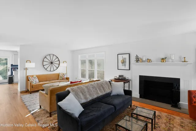 a living room with furniture a fireplace and a window