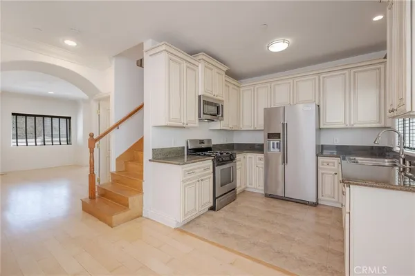 a kitchen with cabinets and stainless steel appliances