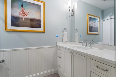 a bathroom with a sink mirror and vanity