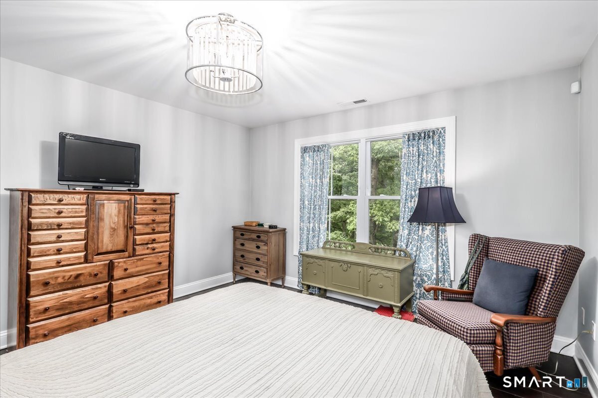127 Putnam Park Road Bethel, CT 06801 - Photo 14 of 35 a bedroom with a bed and a flat screen tv
