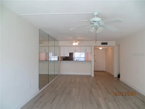 a view of a kitchen with a dishwasher and wooden floor