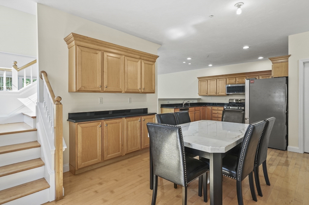 508 Linwood Court, Unit 508 Clinton, MA 01510 - Photo 17 of 32 a kitchen with a table and chairs in it