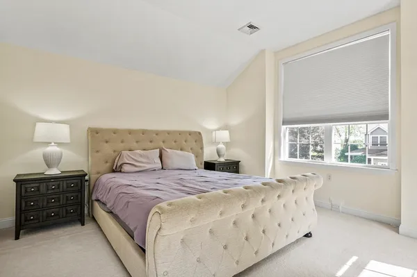 a bedroom with a bed and a window