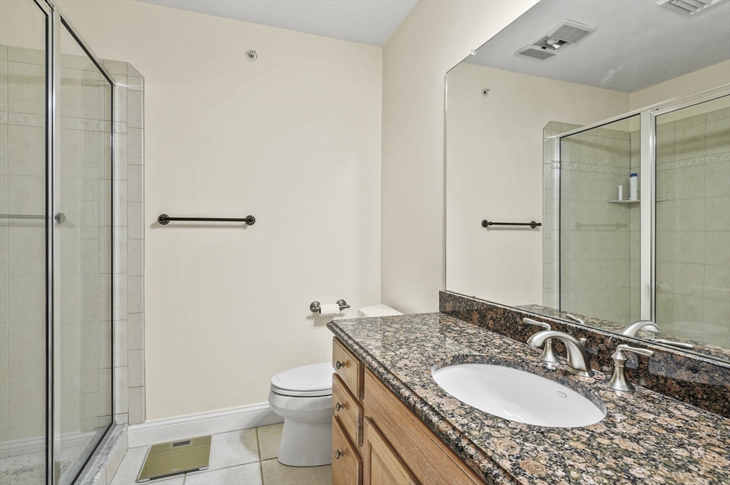 508 Linwood Court, Unit 508 Clinton, MA 01510 - Photo 25 of 32 a bathroom with a granite countertop sink toilet and shower