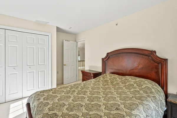 a bedroom with a large bed and a dresser