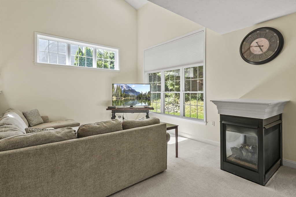 508 Linwood Court, Unit 508 Clinton, MA 01510 - Photo 6 of 32 a living room with furniture and a fireplace