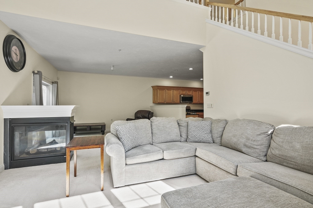 508 Linwood Court, Unit 508 Clinton, MA 01510 - Photo 7 of 32 a living room with furniture and a fireplace