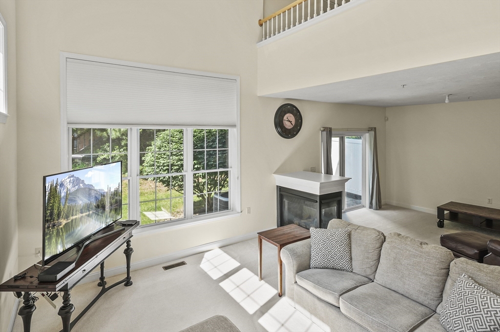 508 Linwood Court, Unit 508 Clinton, MA 01510 - Photo 8 of 32 a living room with furniture and a flat screen tv