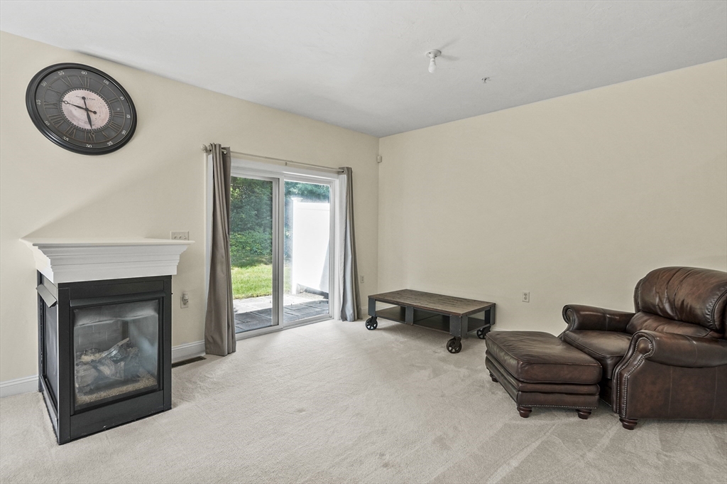 508 Linwood Court, Unit 508 Clinton, MA 01510 - Photo 10 of 32 a living room with furniture and a fireplace