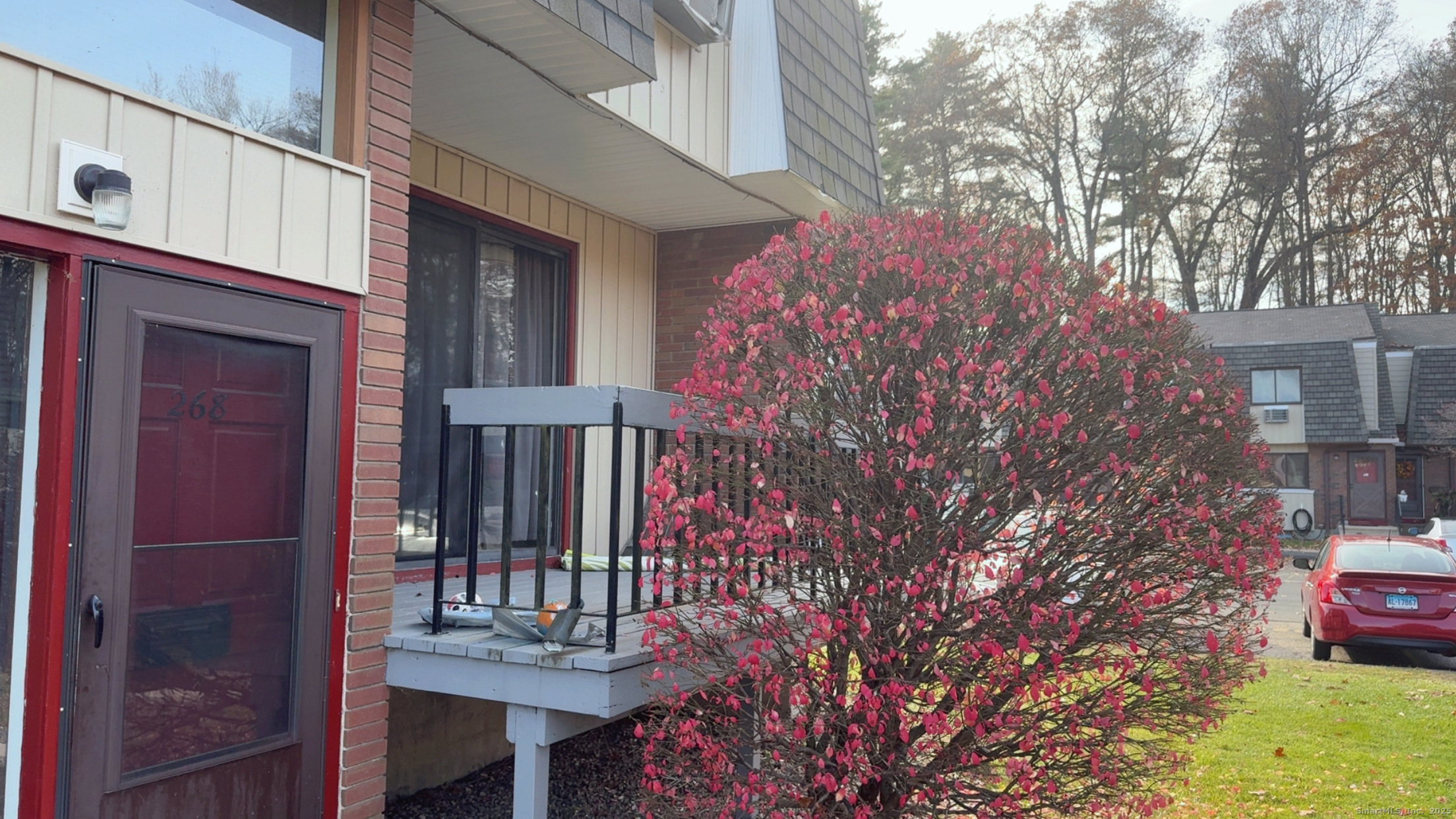 268 High Path Road, Unit 268 Windsor, CT 06095 - Photo 2 of 16 a view of a patio with table and chairs and potted plants