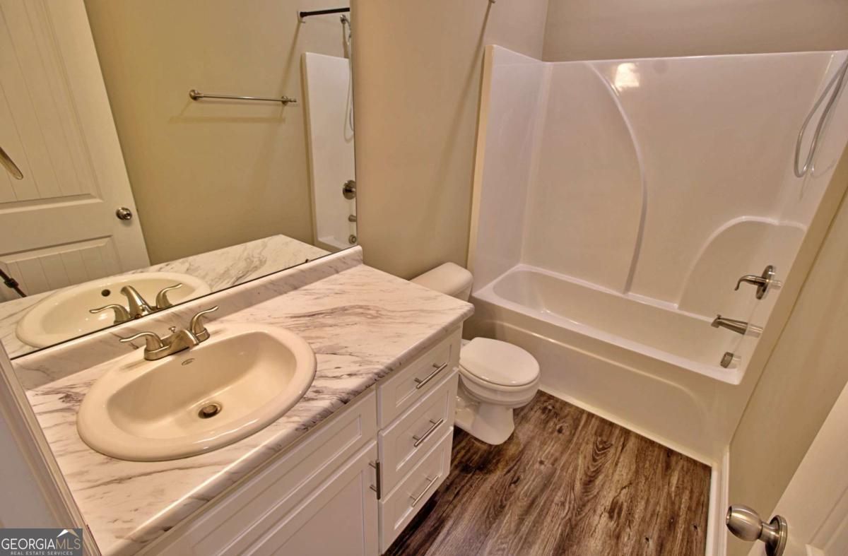 455 Bluff Road Jesup, GA 31545 - Photo 12 of 22 a bathroom with a sink a toilet and shower
