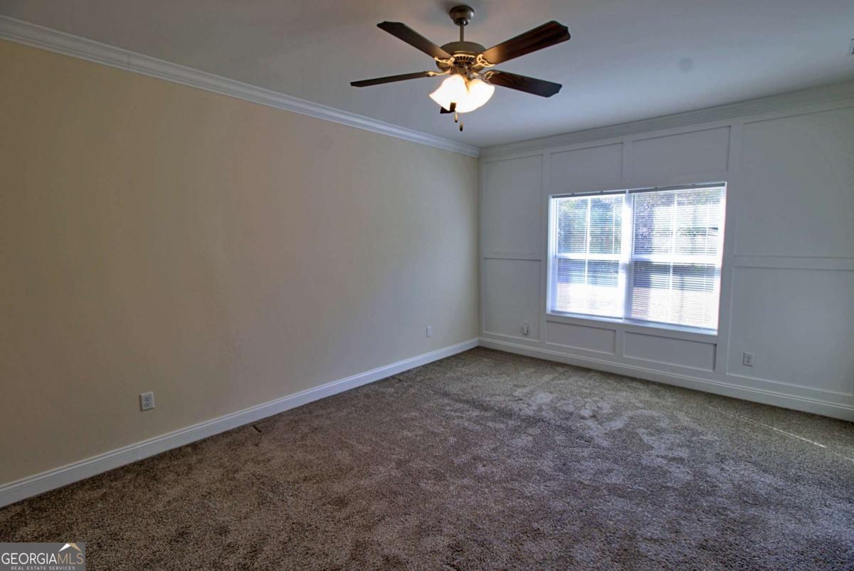 455 Bluff Road Jesup, GA 31545 - Photo 13 of 22 an empty room with a window and a fan