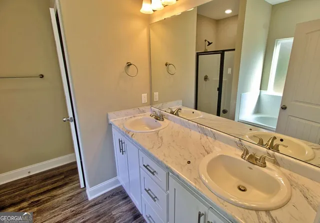 a bathroom with a double vanity sink and a mirror