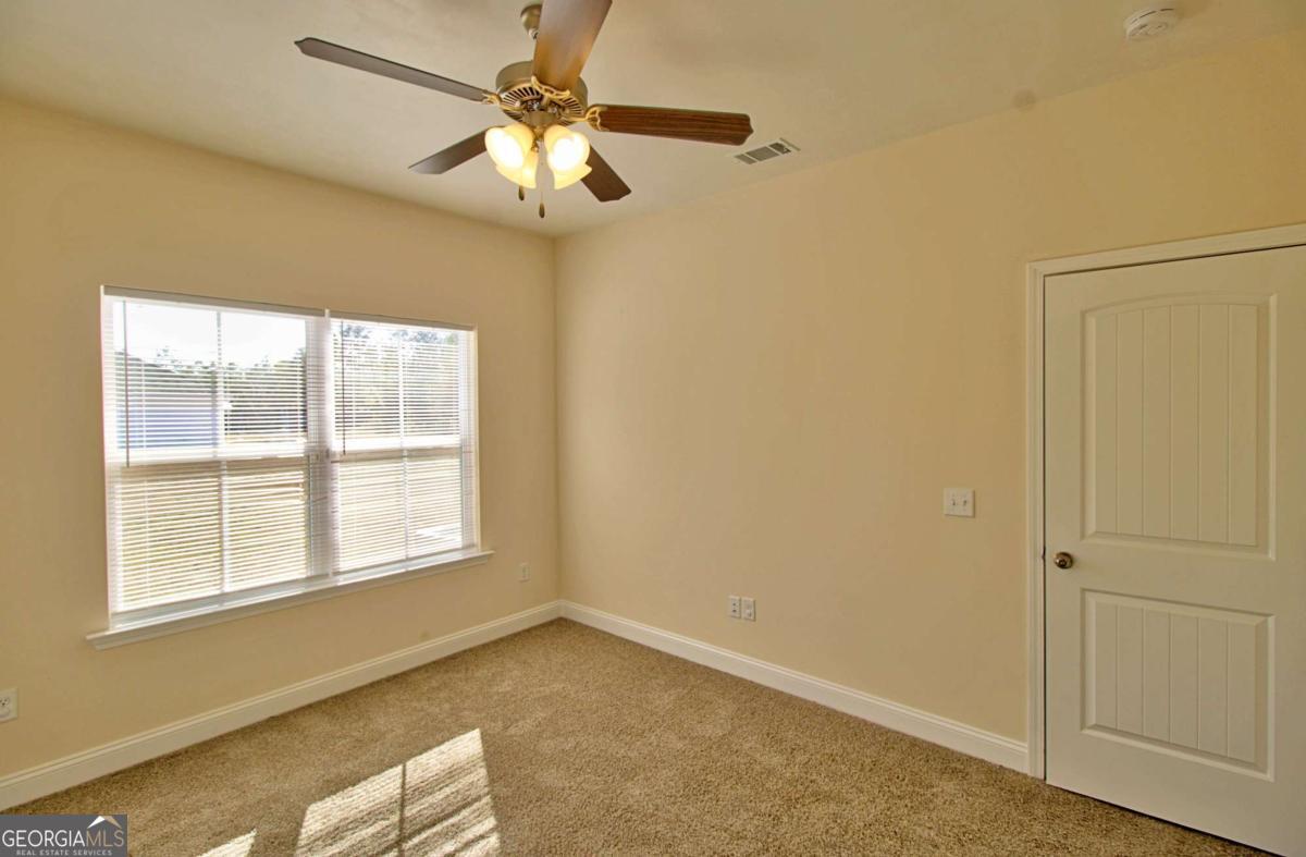 455 Bluff Road Jesup, GA 31545 - Photo 20 of 22 an empty room with windows and fan