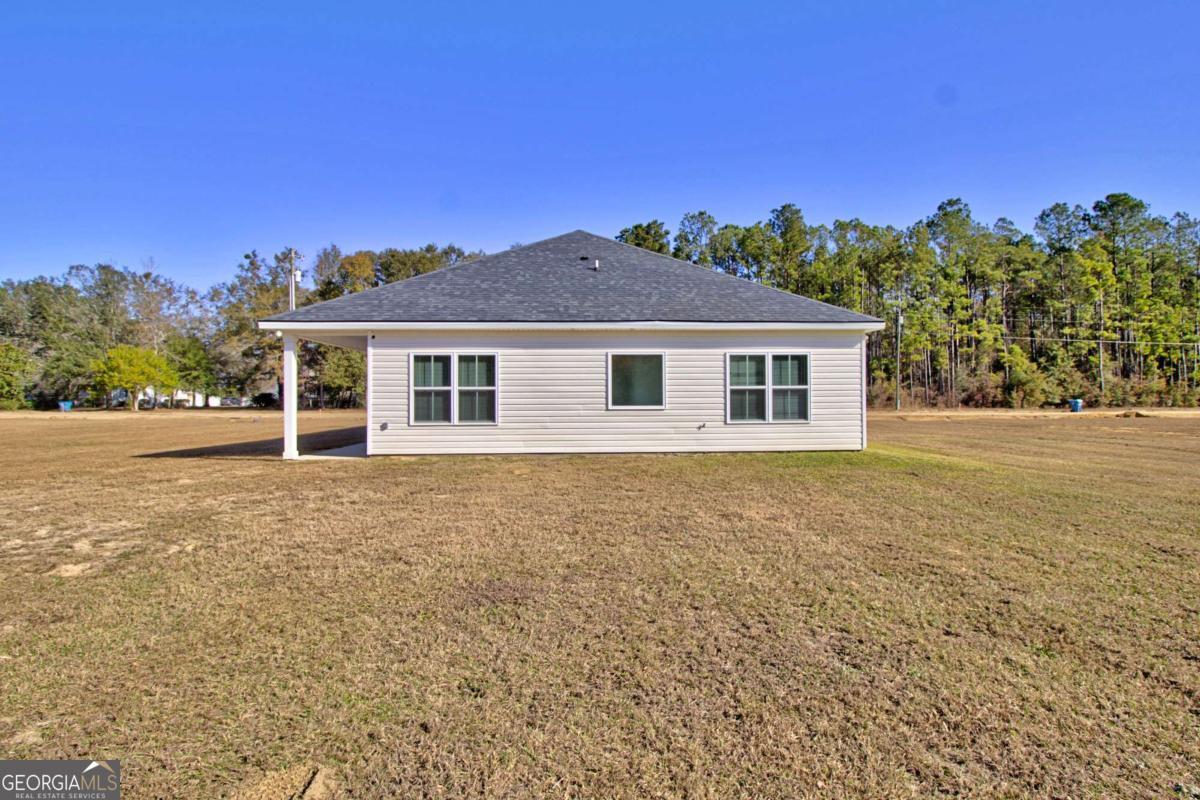 455 Bluff Road Jesup, GA 31545 - Photo 21 of 22 a front view of a house with a yard