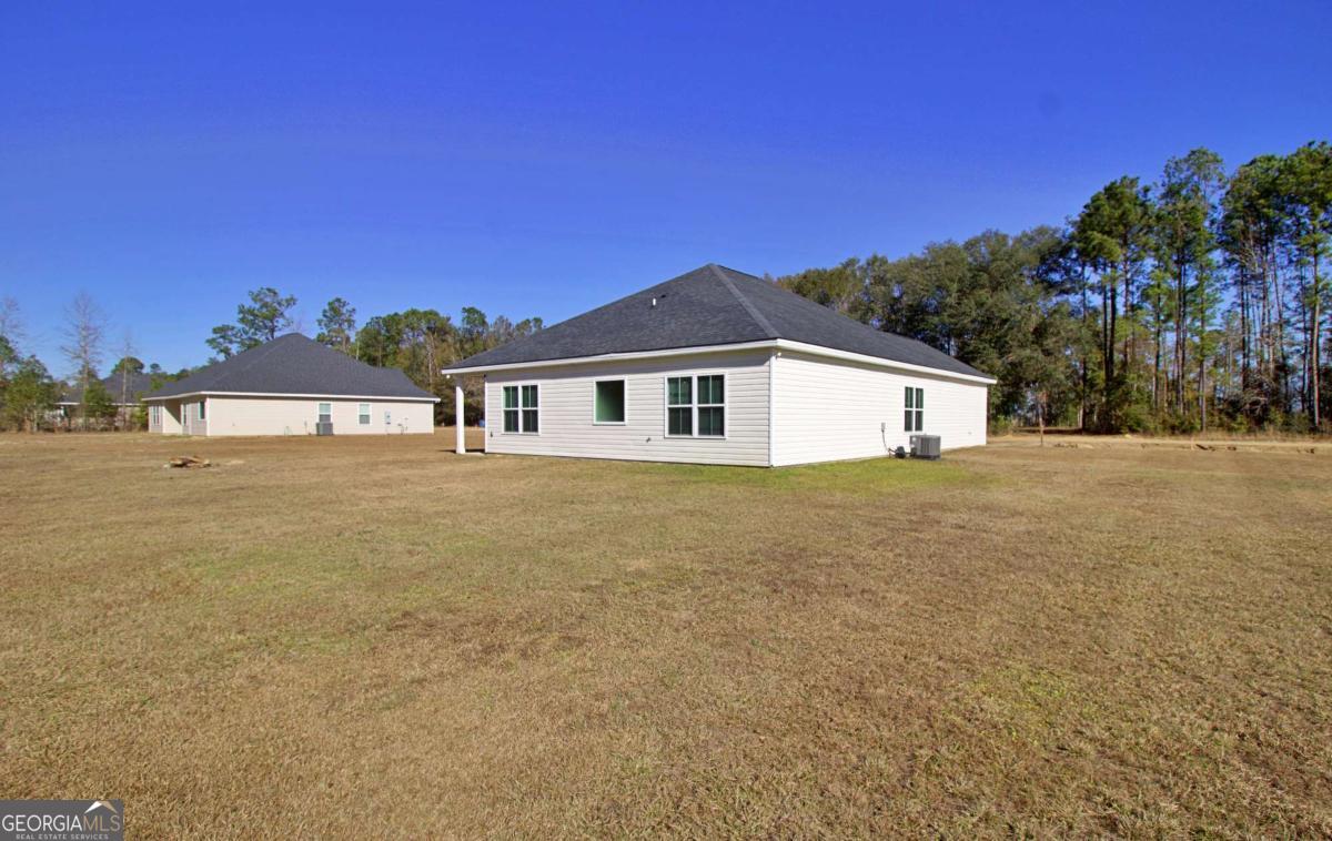 455 Bluff Road Jesup, GA 31545 - Photo 22 of 22 a front view of a house with a yard