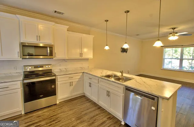 a kitchen with a sink stove and microwave