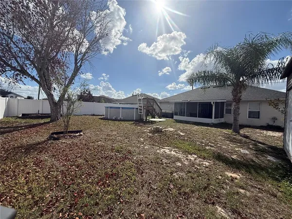 a view of a house with a backyard