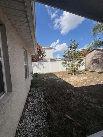 a view of a backyard of the house