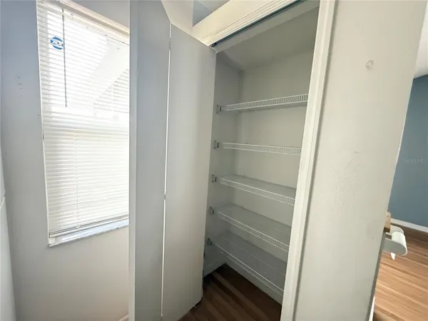 a view of walk in closet with empty racks