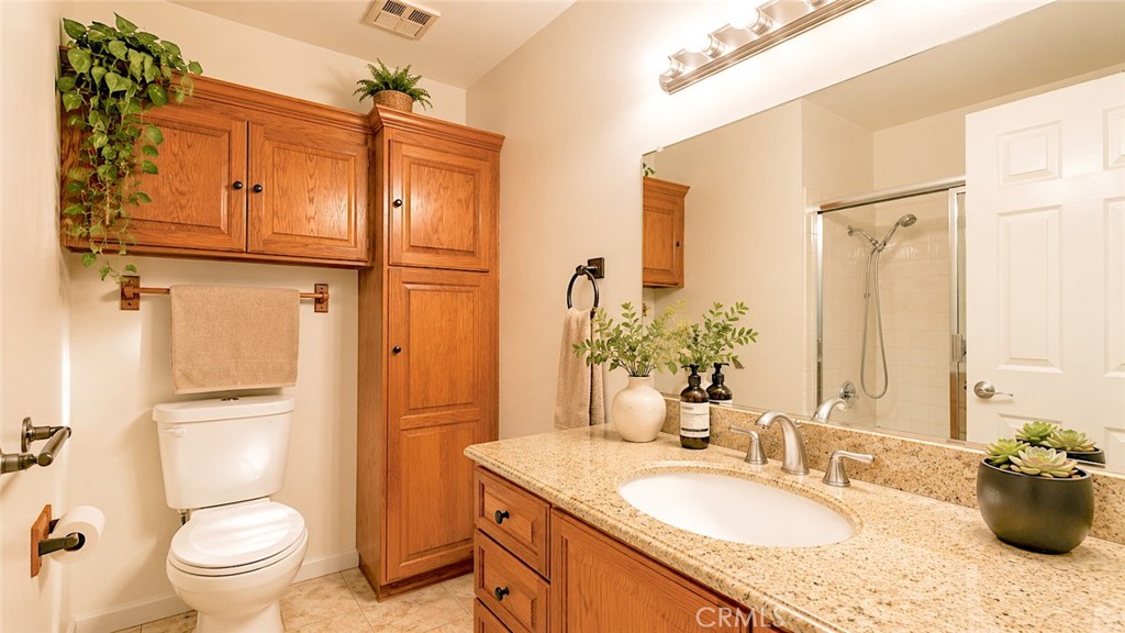 1150 3rd Street Gilroy, CA 95020 - Photo 12 of 28 a bathroom with a granite countertop sink toilet and shower