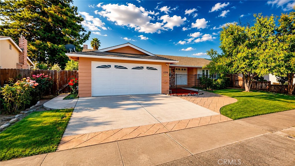 1150 3rd Street Gilroy, CA 95020 - Photo 3 of 28 a front view of a house with a yard and garage
