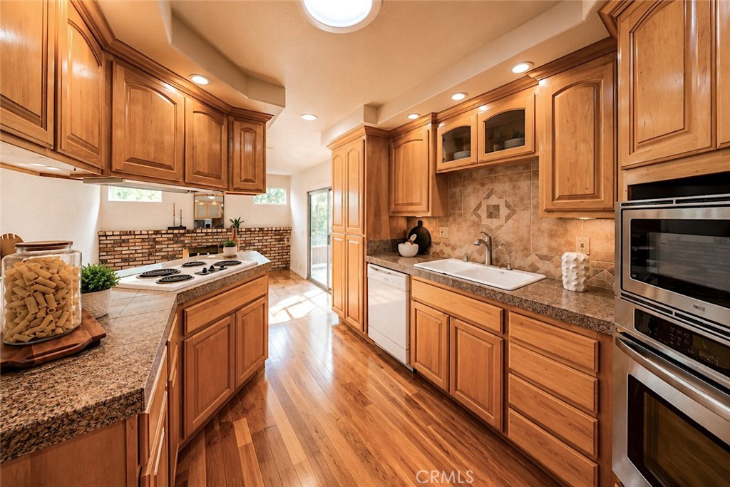 1150 3rd Street Gilroy, CA 95020 - Photo 7 of 28 a kitchen with stainless steel appliances granite countertop a stove a sink and a refrigerator