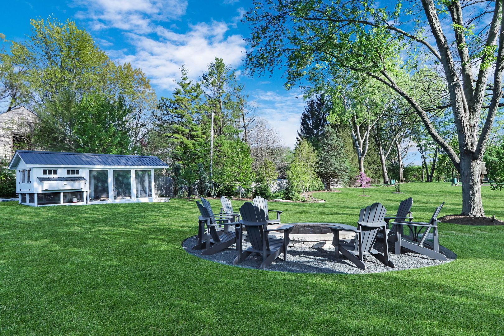 2238 Hanlon Road Libertyville, IL 60048 - Photo 18 of 72 a view of a house with backyard sitting area and garden