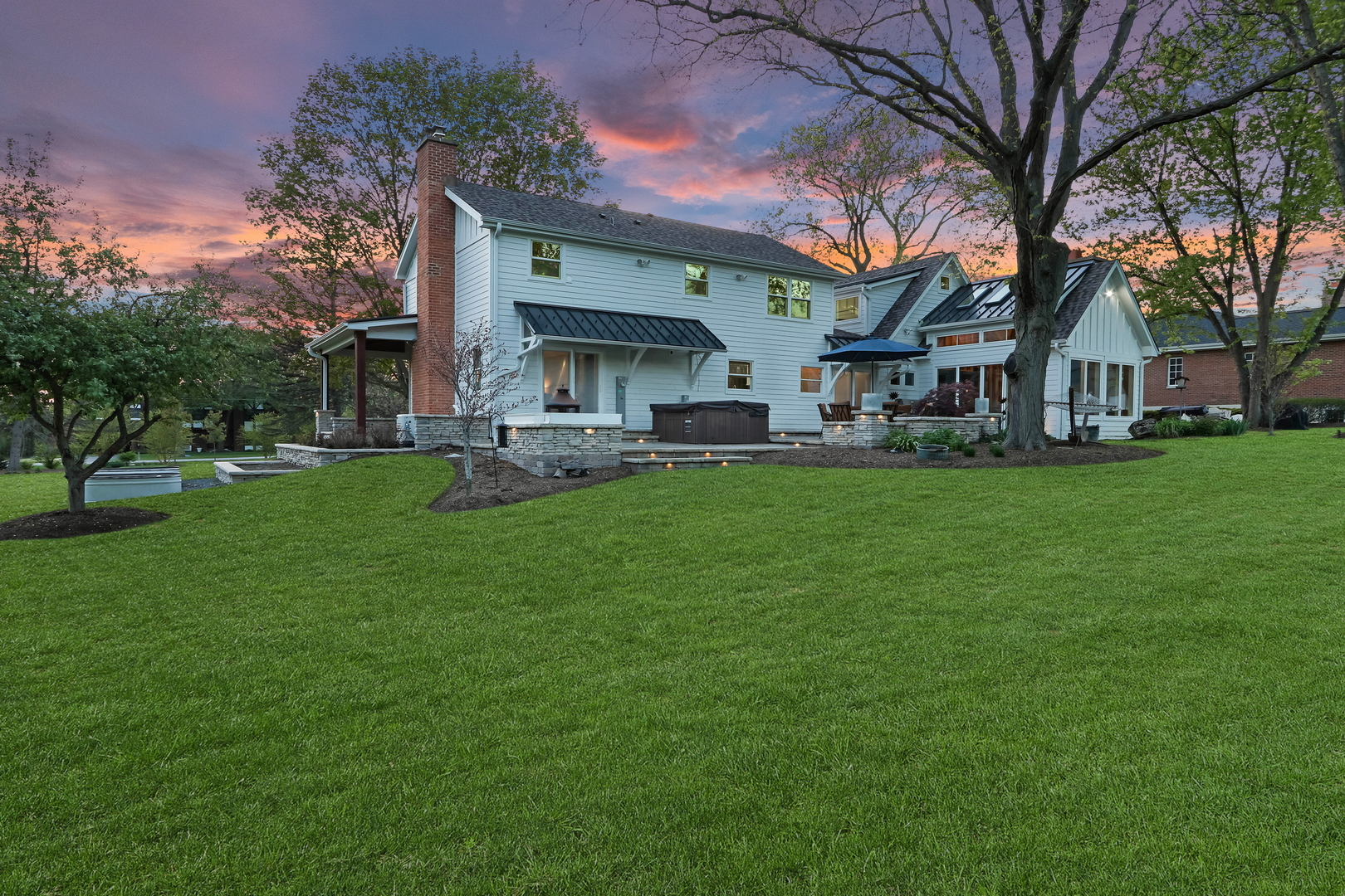 2238 Hanlon Road Libertyville, IL 60048 - Photo 30 of 72 a front view of a house with a garden and trees