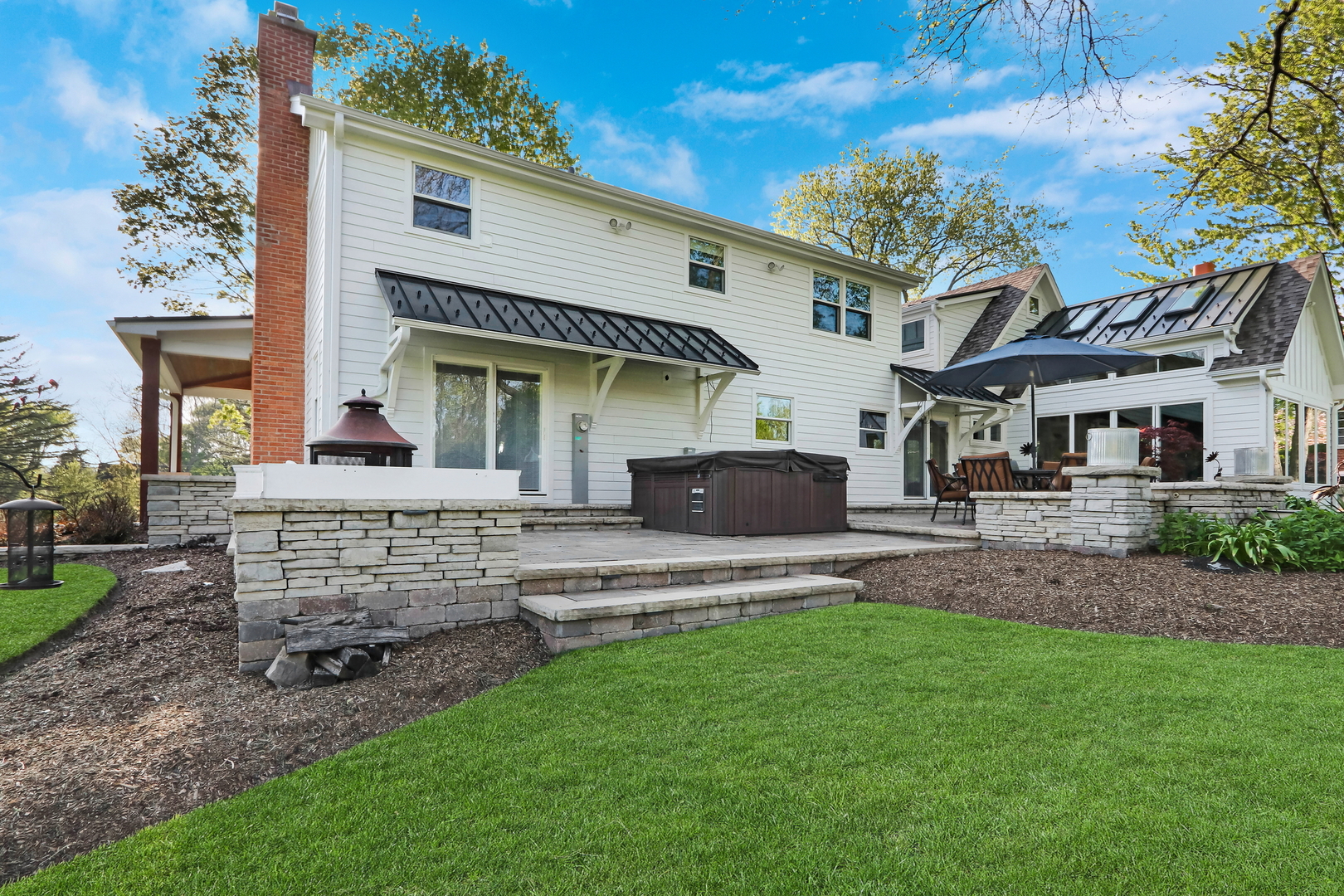 2238 Hanlon Road Libertyville, IL 60048 - Photo 45 of 72 a front view of a house with a garden and outdoor seating