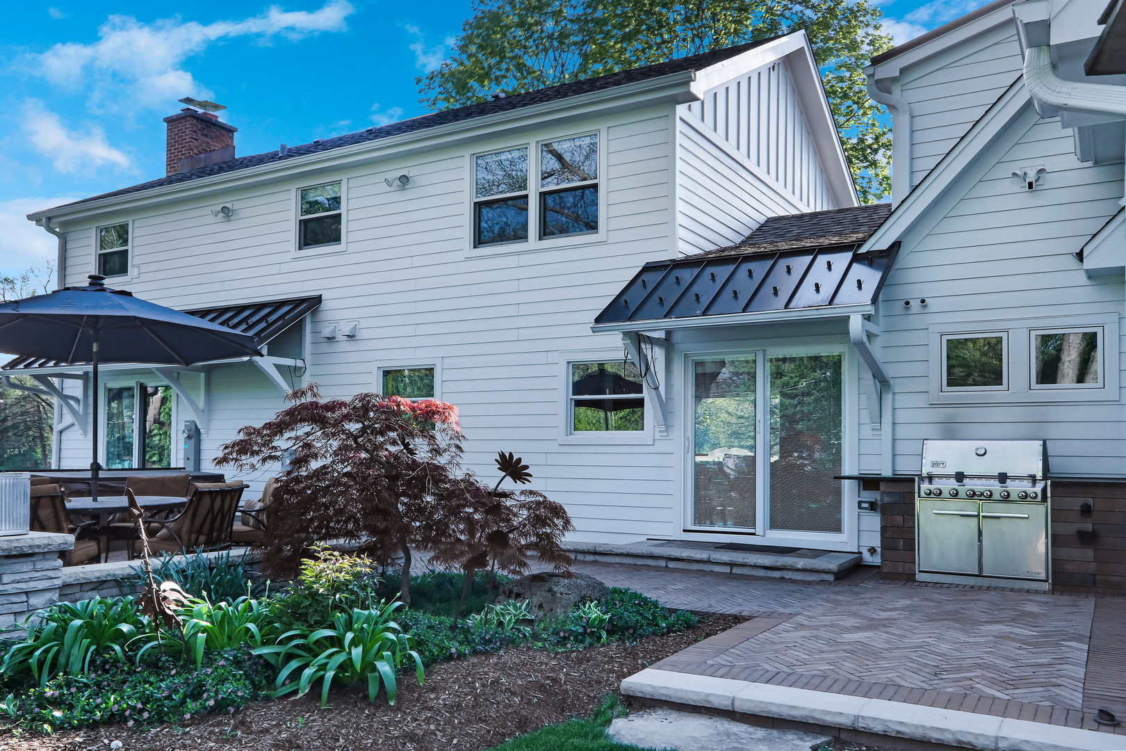 2238 Hanlon Road Libertyville, IL 60048 - Photo 47 of 72 a view of a house with a patio and a yard