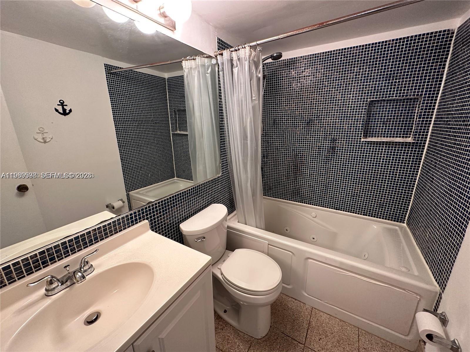 253 South Cypress Road, Unit 214 Pompano Beach, FL 33060 - Photo 9 of 25 a bathroom with a sink toilet and shower