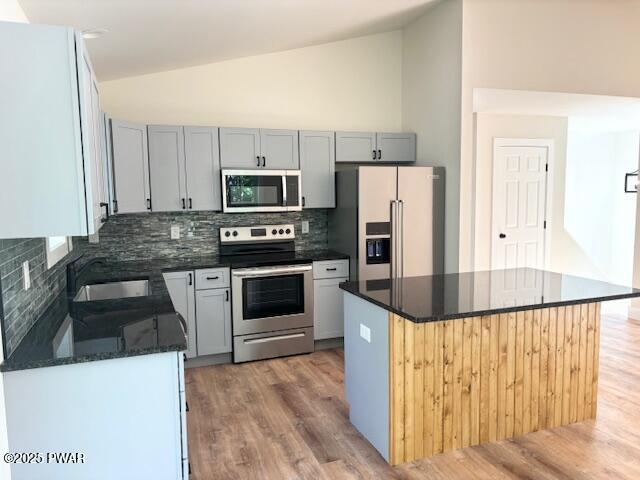 112 Ridge Drive Milford, PA 18337 - Photo 9 of 22 a kitchen with stainless steel appliances a stove a refrigerator a sink and white cabinets