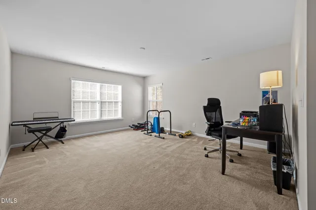 a view of a workspace with furniture and a window