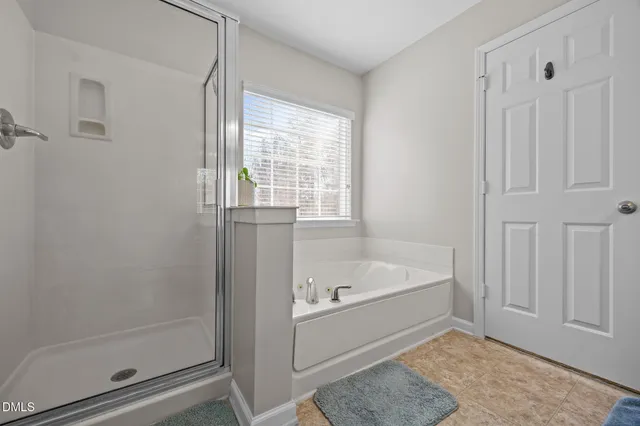 a bathroom with a bathtub and a shower