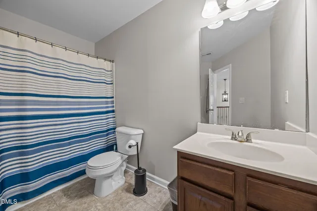 a bathroom with a sink toilet and vanity