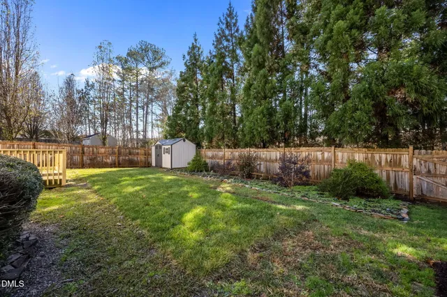 a backyard of a house with lots of green space and fountain