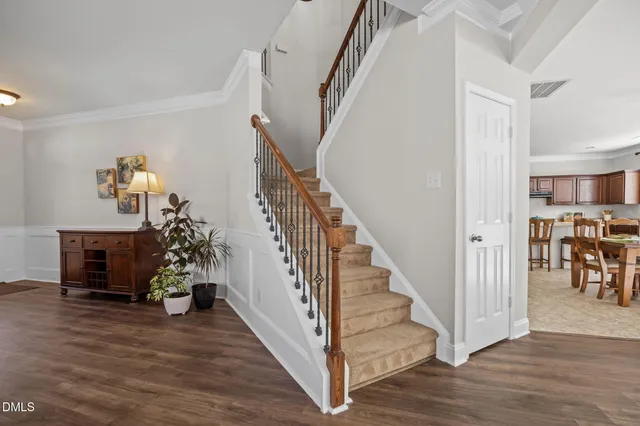 a view of entryway and hall with wooden floor