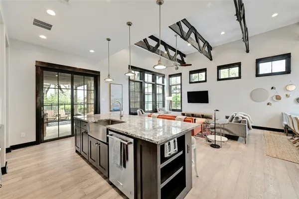 a kitchen with stainless steel appliances granite countertop a sink stove and refrigerator