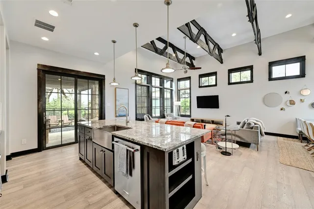 a kitchen with stainless steel appliances granite countertop a sink stove and refrigerator