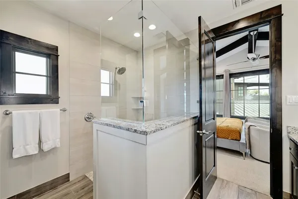 a bathroom with a granite countertop sink and a mirror