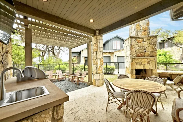 a kitchen with stainless steel appliances kitchen island granite countertop a sink and a refrigerator