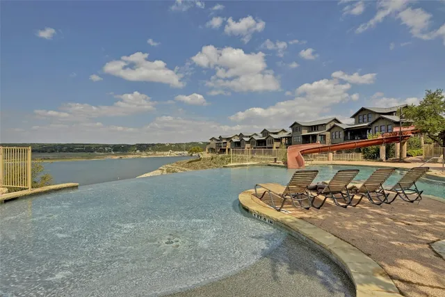 a view of a lake with a table and chairs