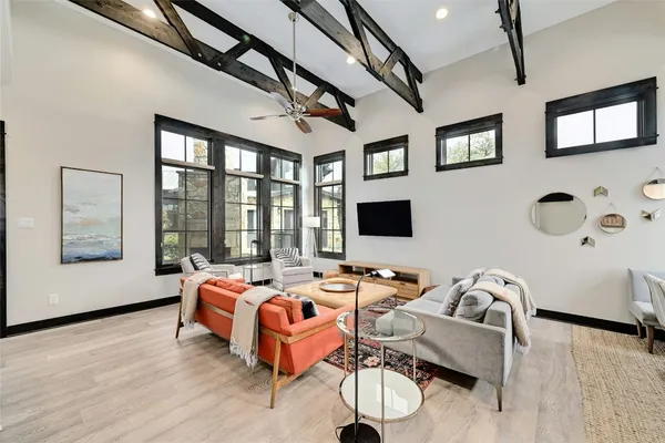 a bedroom with furniture and a flat screen tv