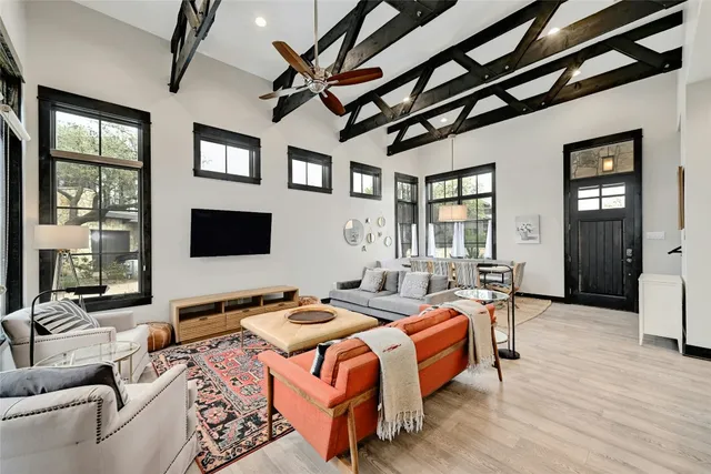 a spacious bedroom with a bed couch and a window