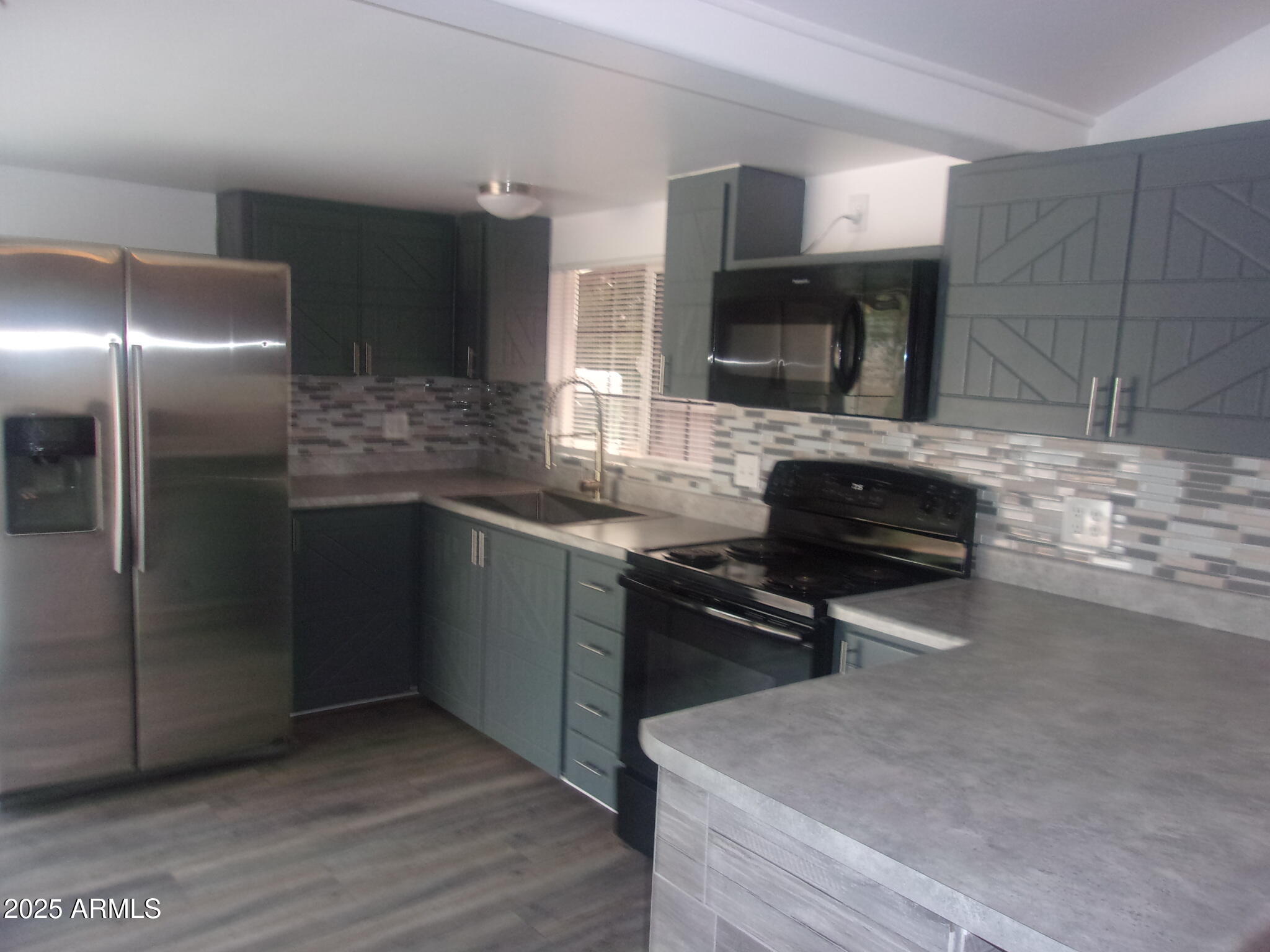 4765 East Valley Lane Rimrock, AZ 86335 - Photo 2 of 25 a kitchen with stainless steel appliances kitchen island granite countertop a stove a sink and a refrigerator