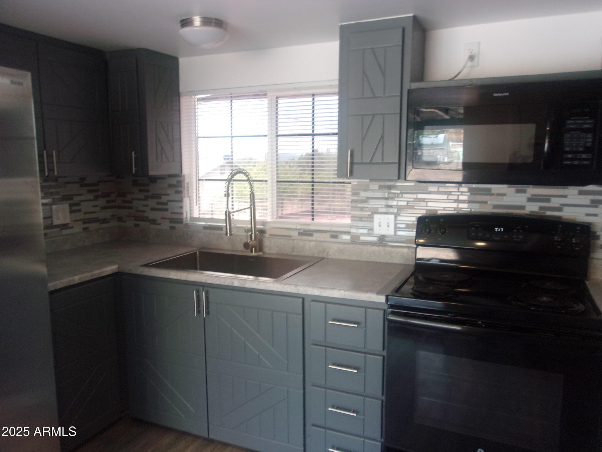 4765 East Valley Lane Rimrock, AZ 86335 - Photo 4 of 25 a kitchen with a sink stove and cabinets
