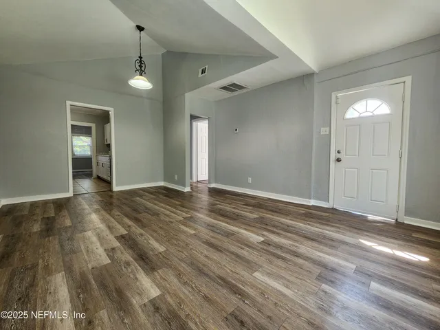 a kitchen with stainless steel appliances a stove a microwave and cabinets