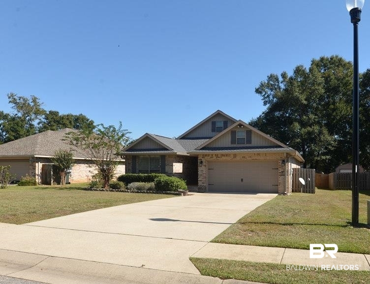 11201 Herschel Loop Daphne, AL 36526 - Photo 29 of 32 View of front facade with a garage and a front lawn