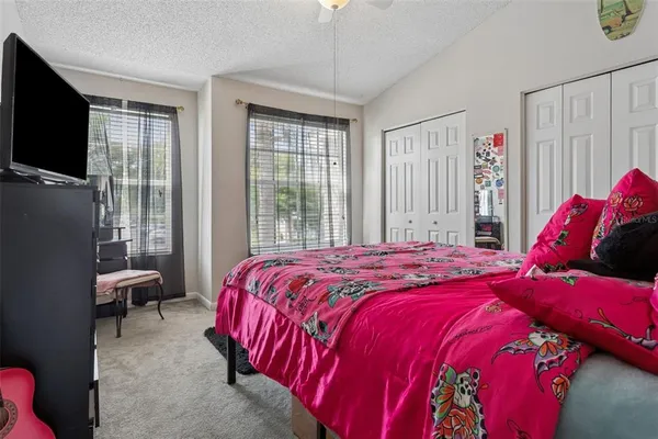 a bed sitting in a bedroom next to a window